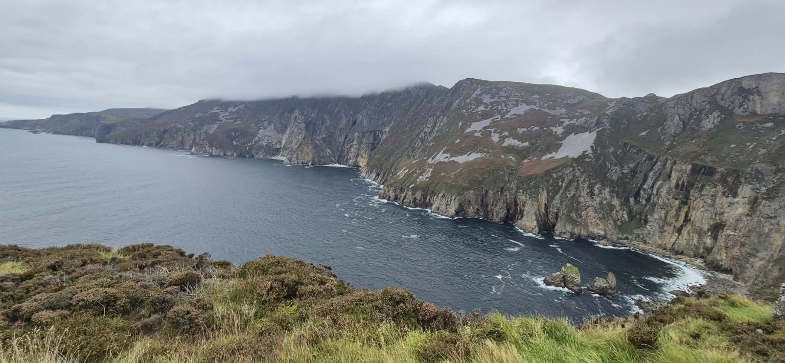 The enormous Slieve League sea cliffs stretching along the Atlantic beneath low cloud