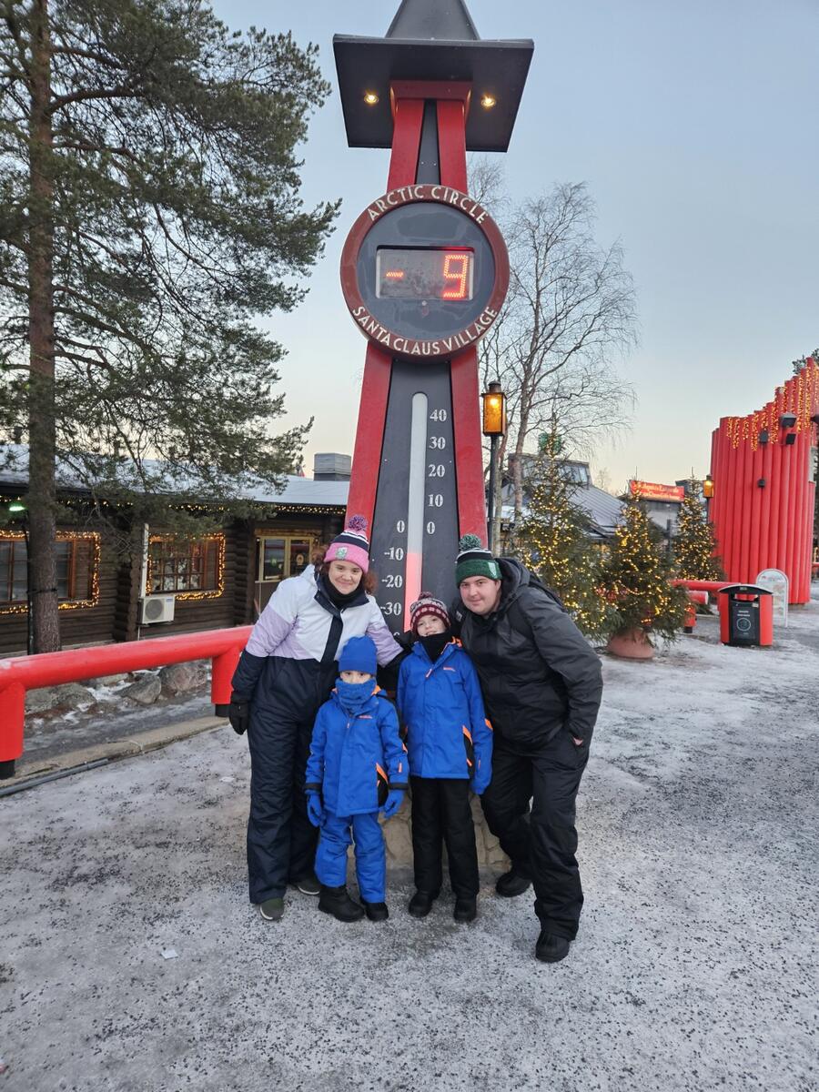Our family beside a winter temperature display in Rovaniemi