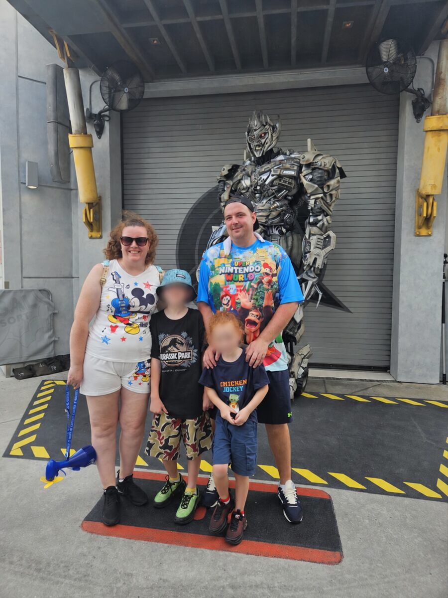 Our family at a monster-themed photo stop in Universal Epic Universe